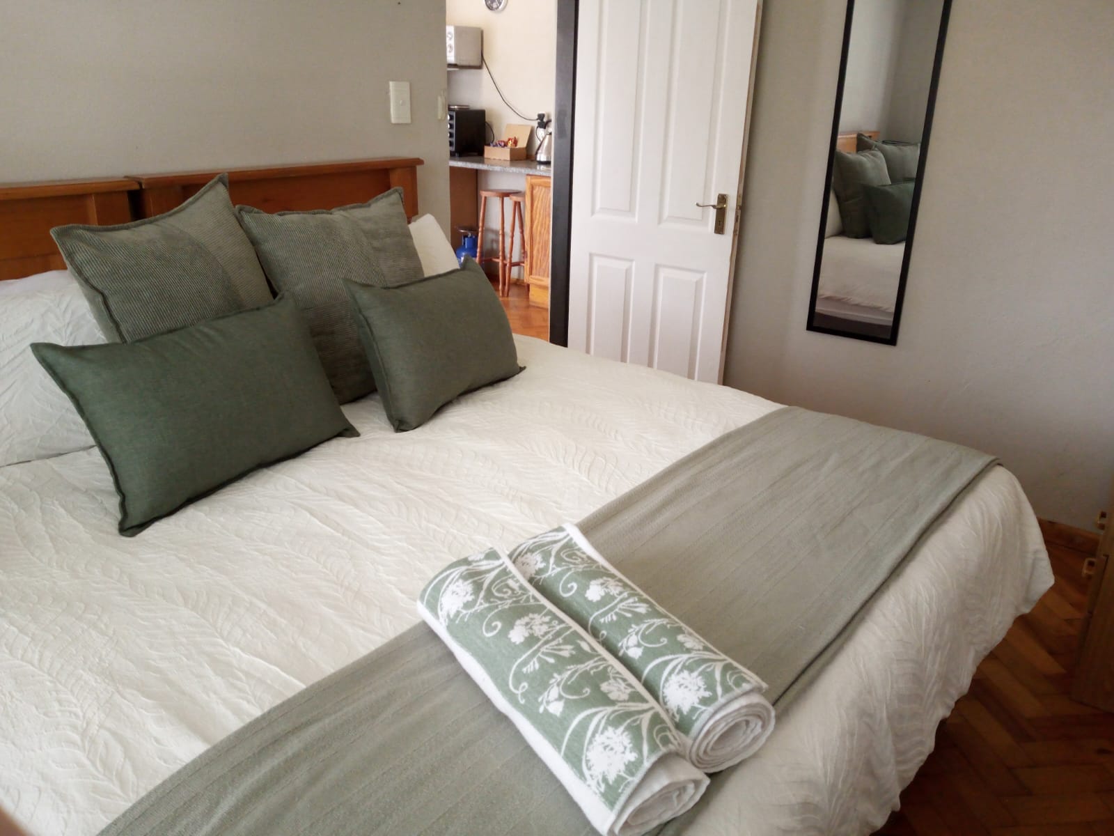 King size bedroom with premium linen in the Wild Olive Suite