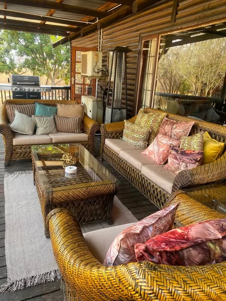 Covered stoep and patio seating overlooking the grounds at Blesbok Lodge